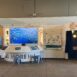 Custom interactive exhibit at the Seymour Marine Discovery Center featuring digital media displays, touchscreen stations, modular artifact cases, and laser-cut kelp-inspired graphics in a Monterey Bay–themed environment.